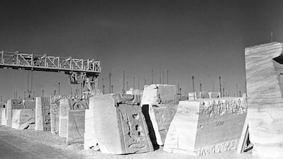 The results of three years of dismantling the temples of Abu Simbel in Egypt lie in a storage area behind the huge escarpment before being moved and re-assembled on higher ground. AP Photo