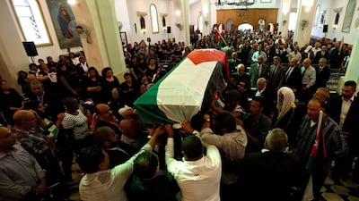 Relatives and activists carry the body of Jordanian writer Nahed Hattar, who was shot dead, during his funeral in the town of Al-uheis near Amman, Jordan, September 28, 2016. REUTERS/Muhammad Hamed