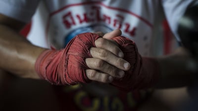 World Boxing Council (WBC) mini-flyweight champion, Wanheng Menayothin, clasping his wrapped knuckles during an interview before a training session in Bangkok. Lillian Suwanrumpha / AFP