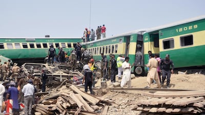 Rescue workers at the scene of a train accident near Sadiqabad, Pakistan. At least 10 people were killed and 40 were injured on 11 July, when a passenger train and a goods train collided near Sadiqabad. EPA