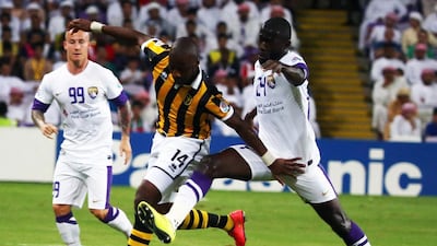 Al Ain midfielders Ahmed Barman, right, and Miroslav Stoch close in on Al Ittihad's Samba Diakite, centre, during their Asian Champions League football match on August 19, 2014 at the Sheikh Hazza bin Zayed Stadium in Al Ain. AFP PHOTO /MARWAN NAAMANI
