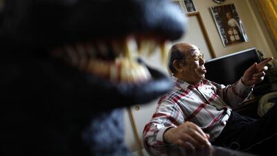 In this Monday, April 28, 2014 photo, original Godzilla suit actor Haruo Nakajima, who has played his role as the monster, speaks during an interview at his home in Sagamihara, near Tokyo. Nakajima, 85, was a stunt actor in samurai films, when he was approached to take the Godzilla role. He had to invent the character from scratch, and went to the zoo to study the way elephants and bears moved. (AP Photo/Junji Kurokawa)