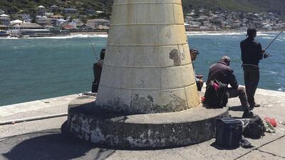Fisherman cast their lines on a windy day in KalkBay near Cape Town. Antonie Robertson