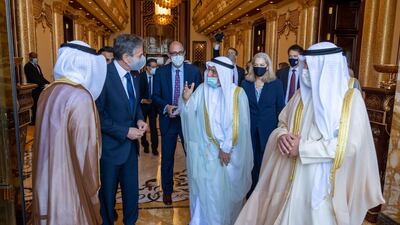 US Secretary of State Antony Blinken and members of the US delegation walks with their Kuwait hosts.