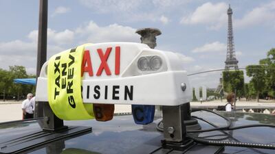 Above, a yellow ribbon indicates a striking Paris taxi. Taxi drivers in teamed up in large numbers to slow traffic to a snail’s pace on major motorway access routes into the capital. Philippe Wojazer / Reuters