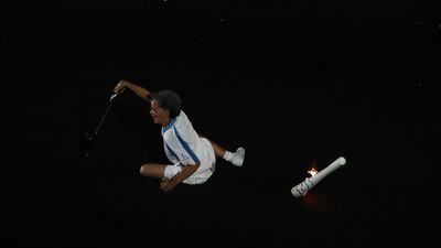 Former Paralympic athlete Marcia Maslar recovers from a fall while carrying the Paralympic flame during the opening ceremony of the Rio 2016 Paralympics Games at the Maracana Stadium. EPA
