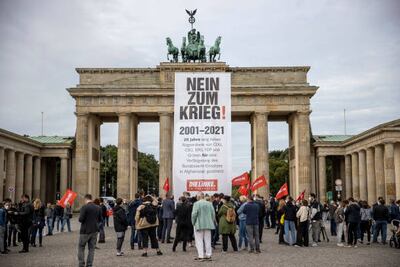Supporters of the Linke party, which hopes to reduce refugee flows by stopping arms exports, hold a protest at the Brandenburg Gate in Berlin. Getty