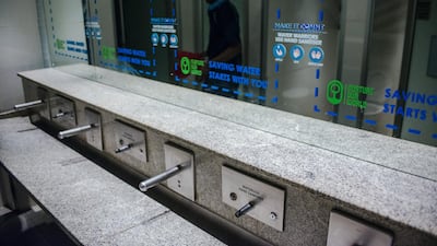 Signage indicating water conservation are displayed on the mirrors in the restrooms on the opening day of the Investing in African Mining Indaba in Cape Town, South Africa. Waldo Swiegers/Bloomberg
