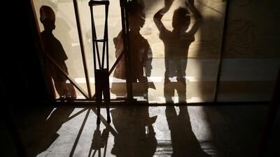 The shadows of crutches and children with special needs are seen on September 29, 2016, during a party for young victims of the Syrian conflict in the rebel-held town of Hamouriyeh, near Damascus, Syria. Bassam Khabieh / Reuters