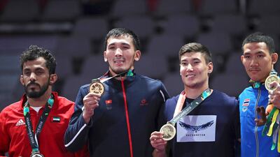UAE's Talib Al Kirbi, left, on the podium after winning a silver medal in the 69-kilogram jiu-jitsu at the Asian Games in Jakarta last year. AP Photo