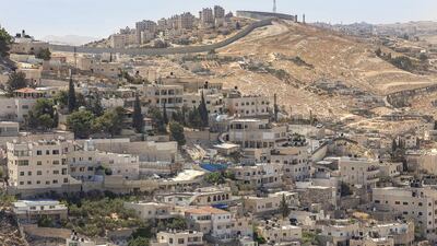 A visit to a Palestine dominated by Israel’s policies, products and separation wall, visible in the picture above of Silwan, near Jerusalem, inspired Ghada Karmi’s second memoir. iStock