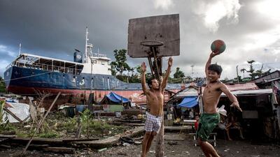 Two men play basketball on a makeshift court in a destroyed township on April 18, 2014 in Tacloban, Leyte, Philippines.Chris McGrath / Getty Images