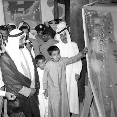 The late Sheikh Zayed with Sheikh Mohamed at the open day at Al Kindi Primary School in Abu Dhabi. Sheikh Mohamed's teacher, Mohamed Al Tamimi is standing behind him. Photo: National Archives