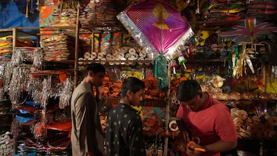 People shop for kites, to take part in good-natured kite-fighting competitions as part of Makar Sankranti celebrations. AP