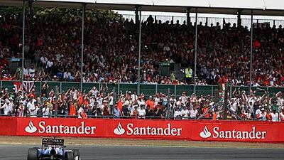 Spectators at last year’s British Grand Prix at Silverstone watch Sebastian Vettel in action in his Red Bull Racing car. A crowd of 120,000 attended that race, and a similar crowd is expected for this Sunday’s race, making it one of the most well attended sporting events in Britain.