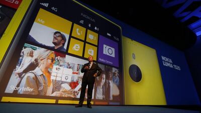 Nokia chief executive Stephen Elop unveils the Lumia 1520, displayed on the giant screen, in Abu Dhabi. The device is priced at $749 and includes a 20MP camera and built-in Microsoft Office. Karim Sahib / AFP