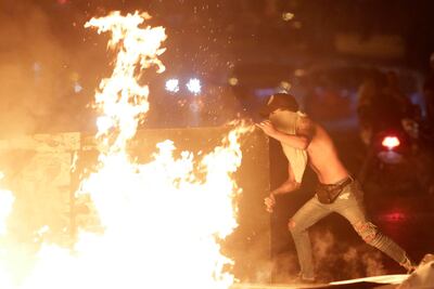 Scores of people are protested across Lebanon over the government's plans to impose new taxes amid a harsh economic crisis in the country. AP