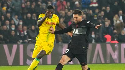 PSG's Lionel Messi and Nantes' Randal Kolo challenge for the ball. AP
