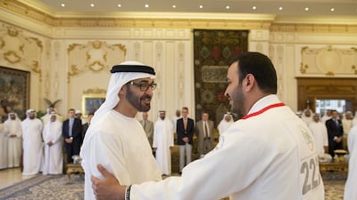 Sheikh Mohammed bin Zayed, Crown Prince of Abu Dhabi and Deputy Supreme Commander of the UAE Armed Forces, left, receives a UAE Jiu-Jitsu participant, who won a medal at the Arabian Gulf Jiu-Jitsu Cup. Ryan Carter / Crown Prince Court — Abu Dhabi