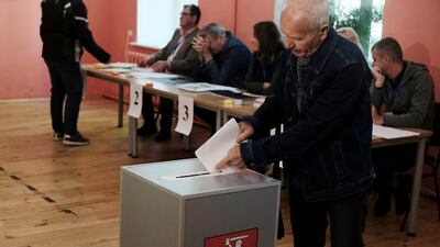 A man casts his vote in Vilnius, Lithuania. Turnout was 59 per cent, the highest in nearly three decades. EPA