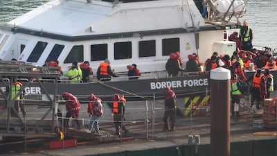 Migrants disembark a UK Border Force vessel at Dover port, after their small boat was intercepted in the Channel. Getty Images