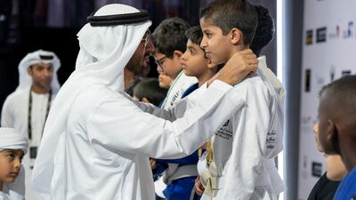 Sheikh Mohammed bin Zayed Al Nahyan Crown Prince of Abu Dhabi Deputy Supreme Commander of the UAE Armed Forces (L), awards a medal to a participant during the Abu Dhabi Jiu-Jitsu Festival. Mohamed Al Hammadi / Crown Prince Court - Abu Dhabi