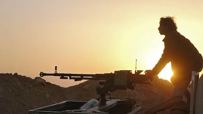 A combatant mans a heavy machine gun as forces loyal to Yemen's government clash with Houthi rebel fighters around the strategic government-held "Mas Camp" military base, in Al Jadaan area about 50 kilometres northwest of Marib in central Yemen, on November 22, 2020. AFP Photo
