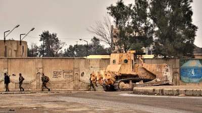 Soldiers clean up in January after the Syrian Democratic Forces retook control of a prison in Hassakeh from ISIS. EPA