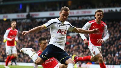 Harry Kane of Tottenham Hotspur shoots under pressure from Laurent Koscielny and Nacho Monreal of Arsenal during their Premier League match on Saturday. Paul Gilham / Getty Images / February 7, 2015