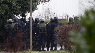 Police officers take position at an industrial area where the suspects are reportedly holding a hostage. Etienne Laurent / EPA