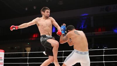 Jason Santana from US, in white shorts, fights with Pavel Gordeev from Russia in the Abu Dhabi Warriors 4 at IPIC Arena in Zayed Sports city in Abu Dhabi. Ravindranath K / The National