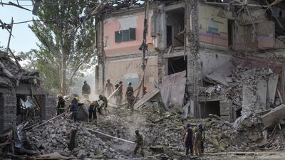 Rescuers and servicemen work at a school building damaged by a Russian military strike in Kramatorsk. Reuters