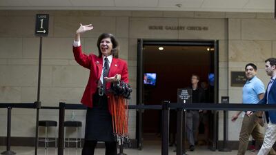 Capitol Visitor Center tour guide Mary Ellen Anderson calls over a group of visitors for the start of a tour on Capitol Hill after reopening. Evan Vucci / AP