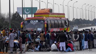 Supporters of former prime minister Imran Khan's Pakistan Tehreek-e-Insaf (PTI) party block the Peshawar to Islambad highway. AFP