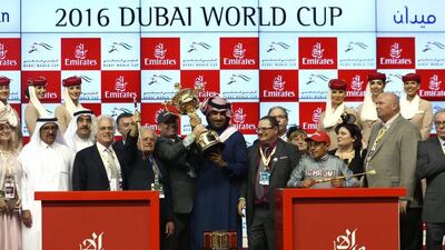 Team California Chrome celebrates with the trophy after victory in the Dubai World Cup Sponsored By Emirates Airline as part of the Dubai World Cup at the Meydan Racecourse on March 26, 2016 in Dubai, United Arab Emirates. (Photo by Warren Little/Getty Images)