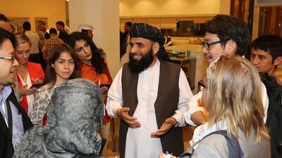 Suhhail Shaheen, a spokesman for the Taliban, meets a group of women at the Intra Afghan Dialogue talks in Doha. AFP