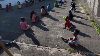 Children wait in lines at a crèche in Langa, near Cape Town. AFP