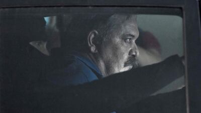 Fugitive Greek neo-Nazi deputy leader Christos Pappas is escorted in a police car after his hearing. AFP