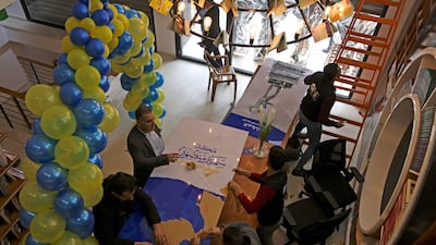 Workers prepare for the opening of the new Samir Mansour bookshop that was destroyed during last year's 11-day war between Israel and the Palestinian Hamas movement, in Gaza City. Mansour's beloved bookshop has been rebuilt and restocked following an international fundraiser.