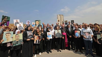 Family members carry the portraits of the victims of 2020 Beirut port blast as they gather alongside ambassadors from several foreign countries near the blast's ground zero on the sixth anniversary of the explosion, in Beirut on August 4, 2026. The massive Beirut port explosion on August 4, 2020. AFP