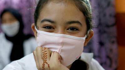 Thirteen-year-old student Chaimaa Talaaloute wears a face mask in the classroom at Mansour Eddahbi College in the Derb El Kabir district of the Al Fida prefecture in Casablanca, Morocco. AP Photo