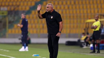 UAE head coach Cosmin Olaroiu passes on instructions.