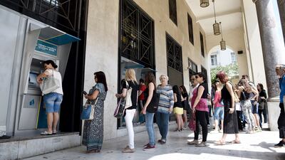 People queuing to use the ATMs in the northern Greek city of Thessaloniki during the recent Greek crisis. UAE bank liquidity is ‘not at Greek levels, but maybe it could go to Italian or Spanish levels at the height of the euro crisis’. Giannis Papanikos / AP Photo