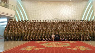 An undated picture released by Rodong Sinmun newspaper, the state-run North Korean newspaper of the ruling Workers Party of North Korean leader Kim Jong-un and his wife Ri Sol-ju posing for a photo with the members of the State Merited Chorus, on the occasion of a concert given to mark the 70th anniversary of the founding of the ruling Workers’ Party of Korea. It was not reported when or where the photo was taken. Rodong Sinmun / EPA