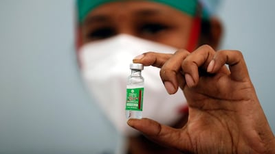 A nurse holds a vial of the Oxford/AstraZeneca Covid-19 vaccine manufactured by Serum Institute of India, which has been given emergency approval by the World Health Organisation. Reuters