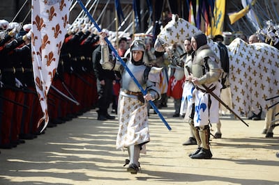 An actress in the role of Joan of Arc performs during a ceremony as part of a presentation of a 15th-century ring believed to have been owned by the French heroine at the Puy du Fou historical theme park in Les Epesses, in 2016. AFP
