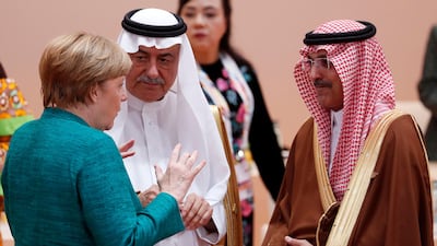 German chancellor Angela Merkel talks to Saudi Arabia's former finance minister Ibrahim Al Assaf, centre, and the current finance minister Mohammed Al Jadaan on July 8, 2017, the second day of the G20 summit in Hamburg, Germany. Felipe Trueba / EPA