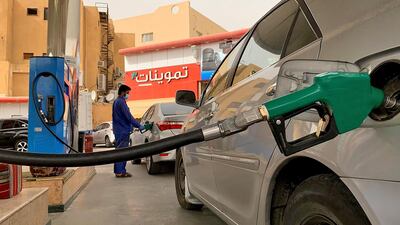 A gas station attendant refills a car at a station in the Saudi capital Riyadh. Saudi Arabia's energy ministry said it had asked oil giant Aramco to make an additional voluntary output cut of one million barrels per day starting from June to support prices. AFP