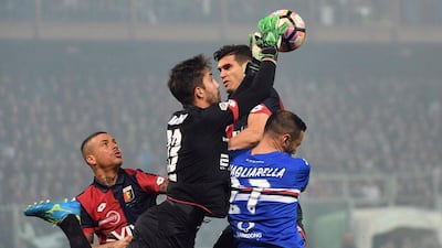 Genoa goalkeeper Eugenio Lamanna, left, blocks a ball as Sampdoria's Fabio Quagliarella, right, jumps on Saturday, March 11 2017. Luca Zennaro / AP Photo