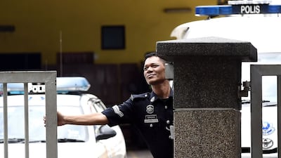 A police officer closes the main gate of the forensics wing of the Hospital Kuala Lumpur in the Malaysian capital, where the body of Kim Jong-nam, the half-brother of North Korean leader Kim Jong-un, is being kept. Manan Vatsyayana / AFP